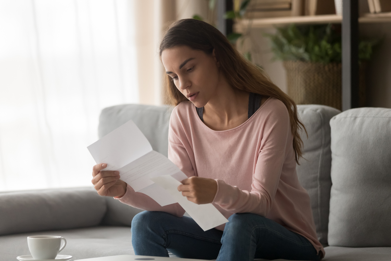 Woman reviewing letter to complete state mandated backflow testing