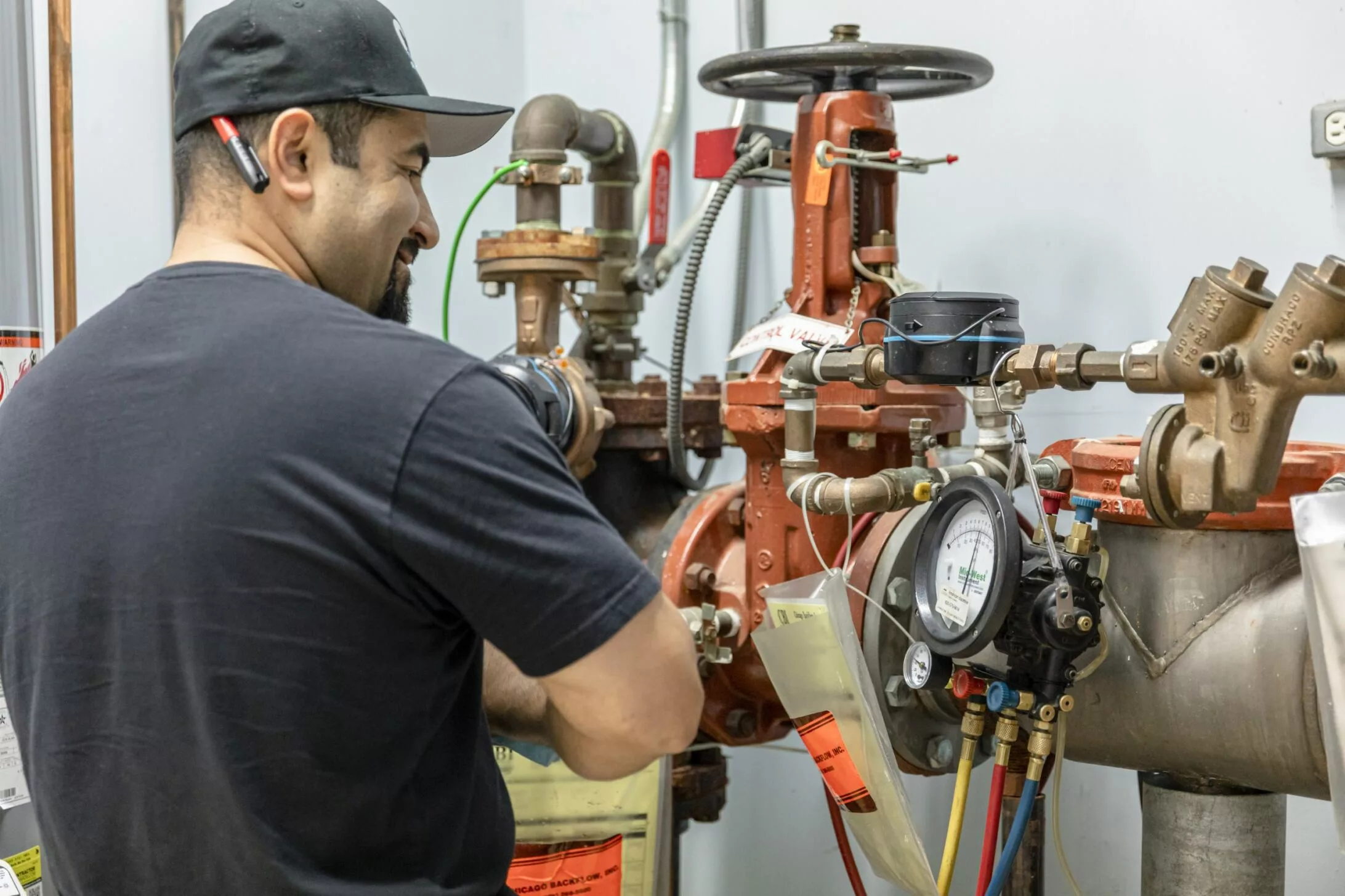 Genaro, a Chicago backflow inc. tech works services a backflow device