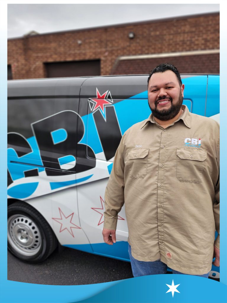One of Chicago Backflow's professional tester next to a branded work van
